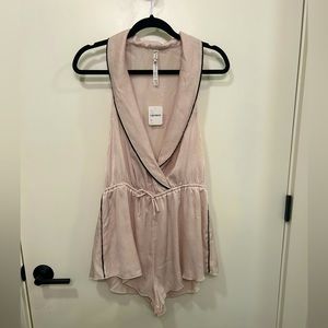 Free People blush pajama romper with black detail, size M.